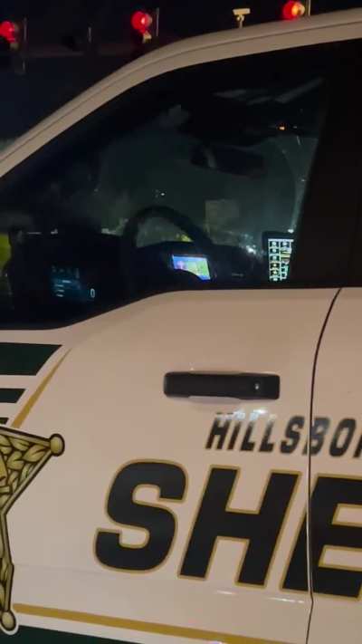 Hillsborough Sheriff watching football while driving at night