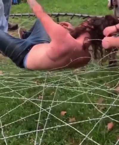 Man jumps onto trampoline of wire