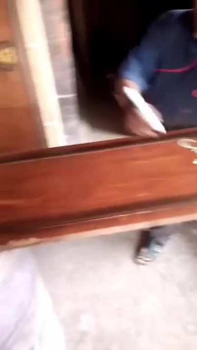 Guy free-hands embellishments on door panel