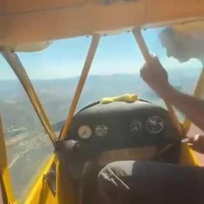 hand starting a plane mid air