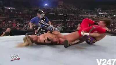 Eddie Guerrero executes a sunset flip on Chris Benoit who suplexes Edge at the same time