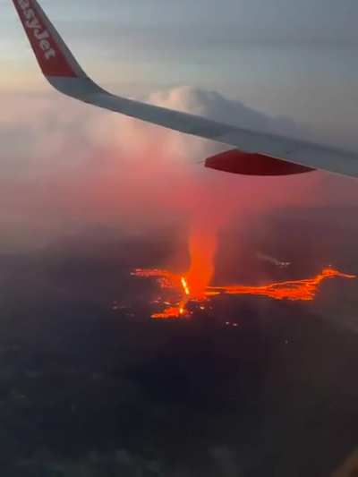 Moment easy Jet plane flies over erupting Iceland volcano