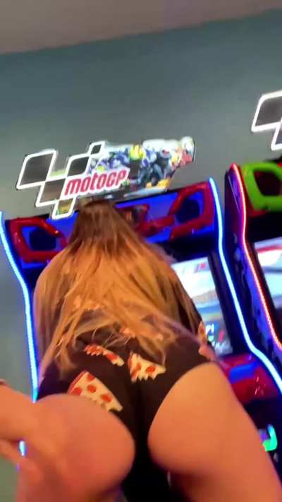 Flashing and eating her pussy in the middle of the arcade