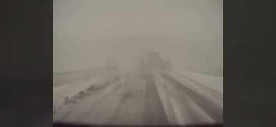 Semi driving too fast for conditions in Midwestern United States during an unseasonably late blizzard.