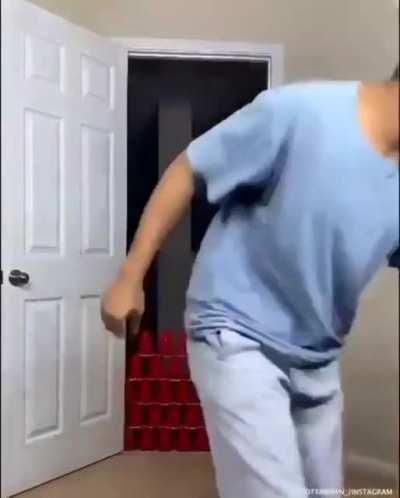 trying to jump over cups in doorway