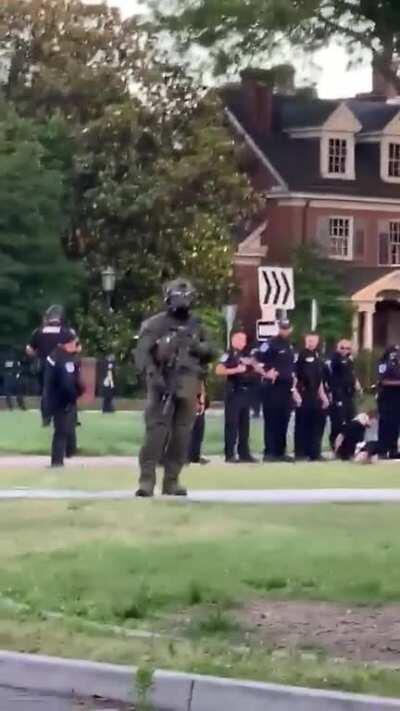 Police officer in Richmond, VA spits on and near a detained protester multiple times, during a pandemic.