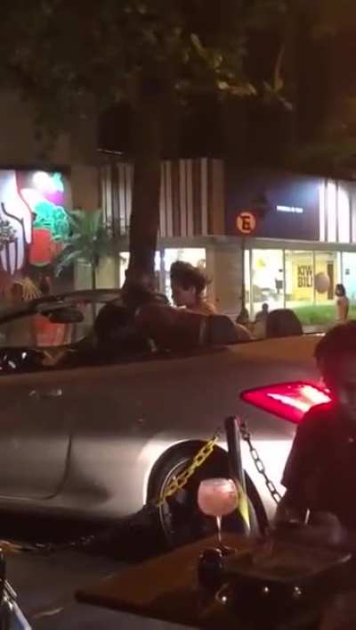 Throwing trash at a woman in a bikini