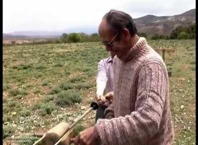 Smashing grass fibers to braid into traditional hemp rope