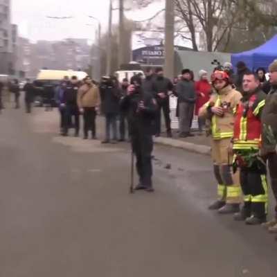 Rescuers and other service workers who assisted in the aftermath of the rocket attack on a high-rise building in Dnipro paid tribute to those who died