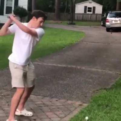 Playing golf in the yard.