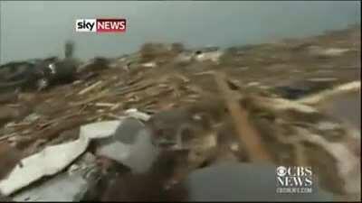 Tornado survivor finds dog buried alive under rubble in the middle of a news interview.