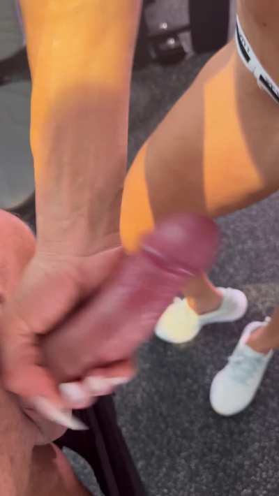 A quick handjob on the sneak in the gym