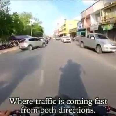 Biker seess a little girl having a seizure while stuck in a traffic jam, rushes both her and her father to a hospital on his motorcycle