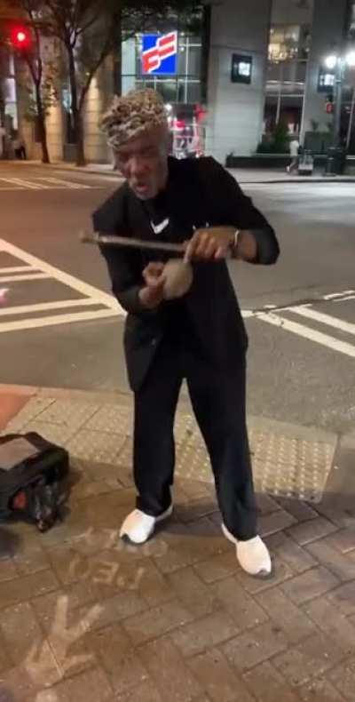 Street magician wants you to watch his wand.