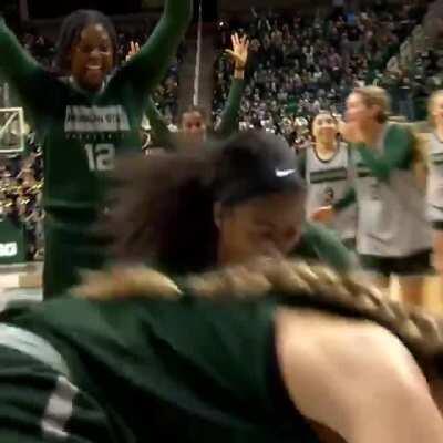 The girl from the opposing team in the background.