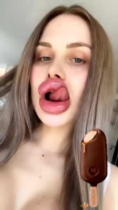 Licking her enormous pecker pillows