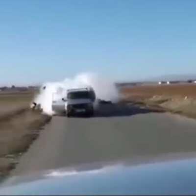 A guy tries to shoots an “RPG” in the back of a car, but it back fires... ( it doesn’t look like an rpg but idk)