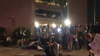 Volunteer medics advised by police to bring a critically wounded protestor to the police line for medical attention were fired upon. This is moments after they opened fire. The lead medics hand was broken from a bean bag round.