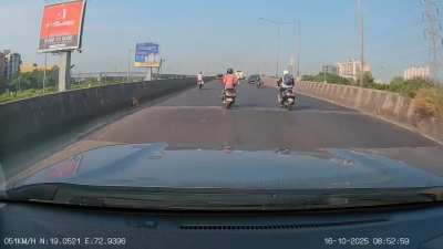 🚨 Ahmedabad, Gujarat: Dashcam captures moment a scooter rider, distracted by phone, loses balance and falls in front of a car — driver narrowly avoids a crash.