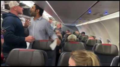 American Airlines passenger who said an anti-Semitic slur is put in a headlock and dragged out by a fellow flyer.