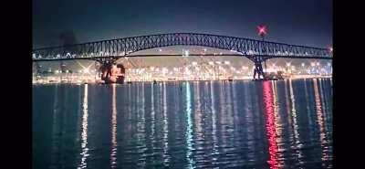 Massive ship hits large bridge, bridge collapses like house of cards. 