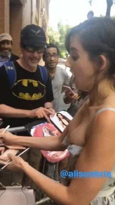Alison Brie gives an autograph session with her tits almost spilling out of her dress