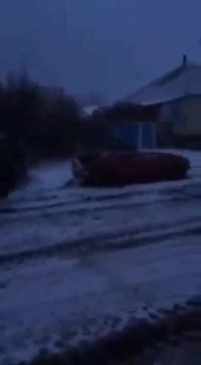 Russian occupiers running over empty civilian vehicle for fun