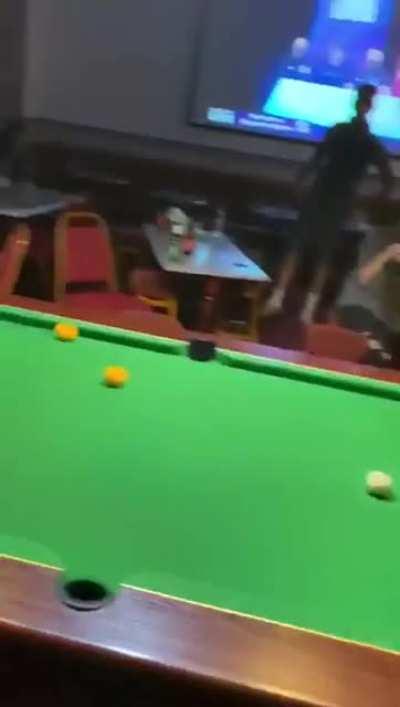 Guys being pool cues