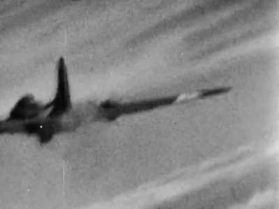 USAAF B-17 Flying Fortress with #1 engine feathered and ball turret in the gunner exit position raked with cannon fire at point blank range from a Luftwaffe Fw 190 circa 1944