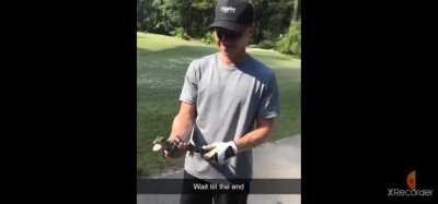 Holding a baby crocodile.