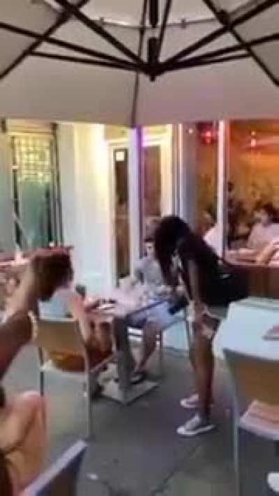 Karen goes to a restaurant and demands that everyone raise their fist. She becomes enraged when one couple does not comply