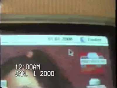 A guy checks his computer on New Year's night, 2000.