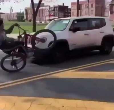 Bike plays chicken with oncoming cars