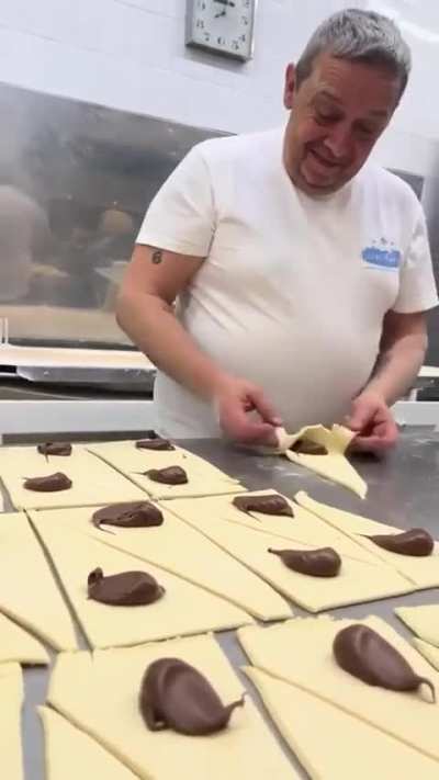 Folding croissants with chocolate filling (Source link in description)