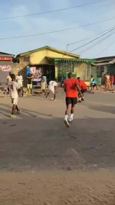 Playing ball in the middle of the street.