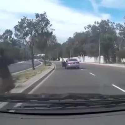 Woman gets out of car and car keeps going.