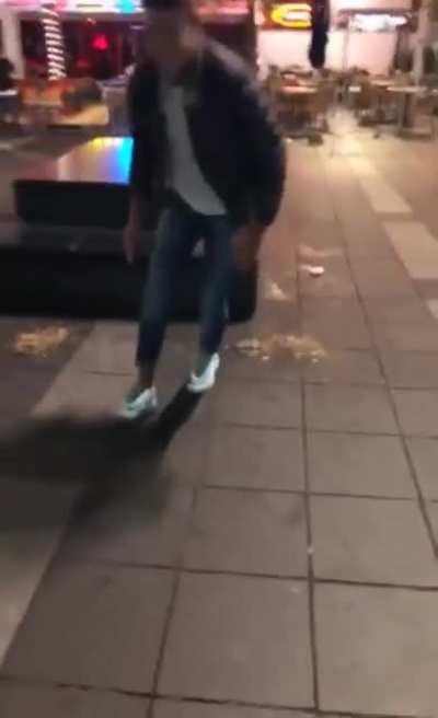 Dude tries to kick pigeon but instead slips and falls in puke.