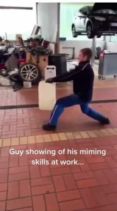 Man so good at miming that he made it seem as if the bin in his hand was stuck floating in one spot midair