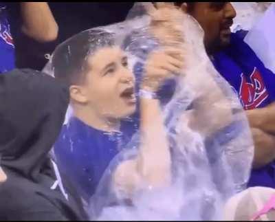 A Cubs fan struggling to figure out how to put on his poncho