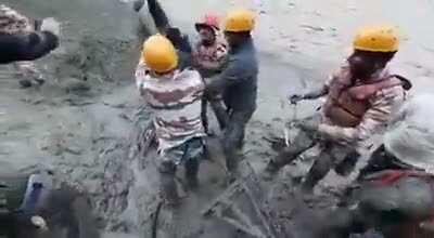 Rescue team pulls out a construction worker trapped in a tunnel after flash floods in Uttarakhand, India