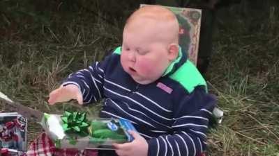 His reaction to unwrapping a gift