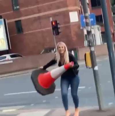 [UK] Woman picks a cone and a police car is right behind her