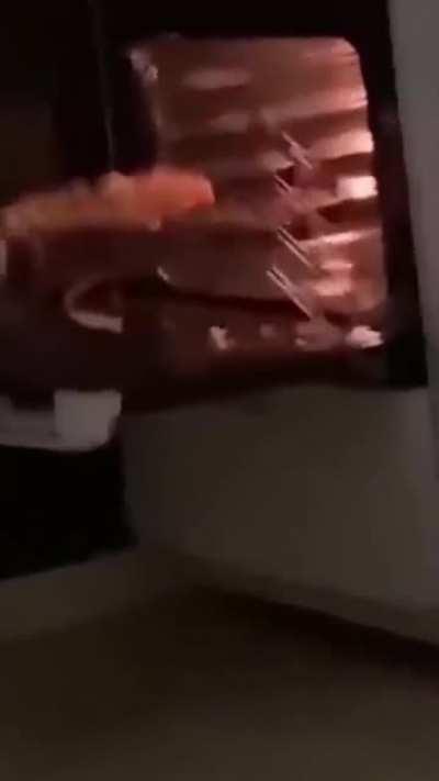 WCGW trying to take the pizza out of the oven with one hand.