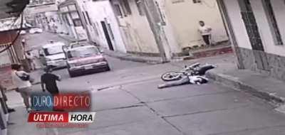 Motorcyclist sent flying into corner of building after being hit by a truck
