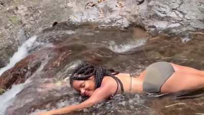 Halle relaxing at a river falls (IG story 3.30.26)