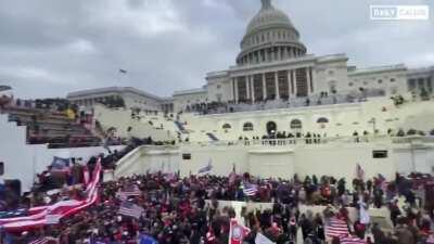 Excellent overview of the enormous crowds in front of the Capitol Building, as they start singing the National Anthem