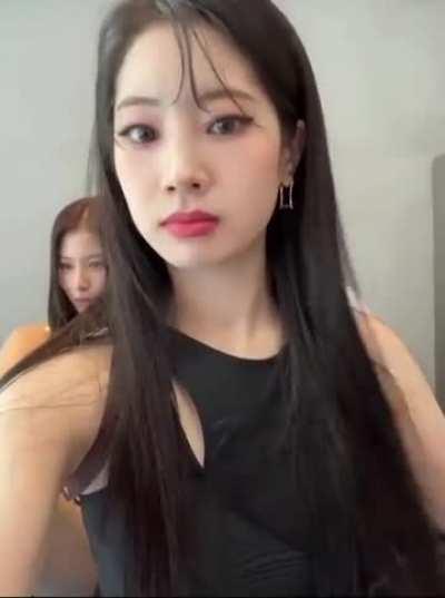 Dahyun fixing her hair and laughing