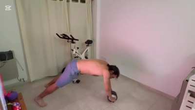 Standing ab wheel with ankle weights.