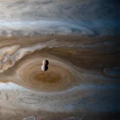 From the Cassini spacecraft: the moons Io and Europa passing Jupiter
