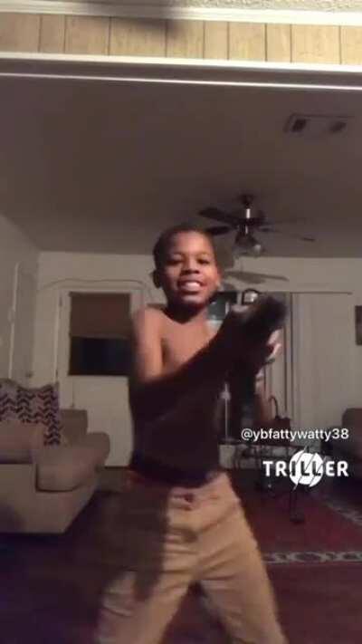 Little kid dances with multiple guns